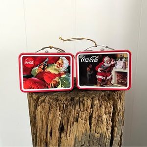 2 vintage tin opening Coca Cola Christmas ornaments.